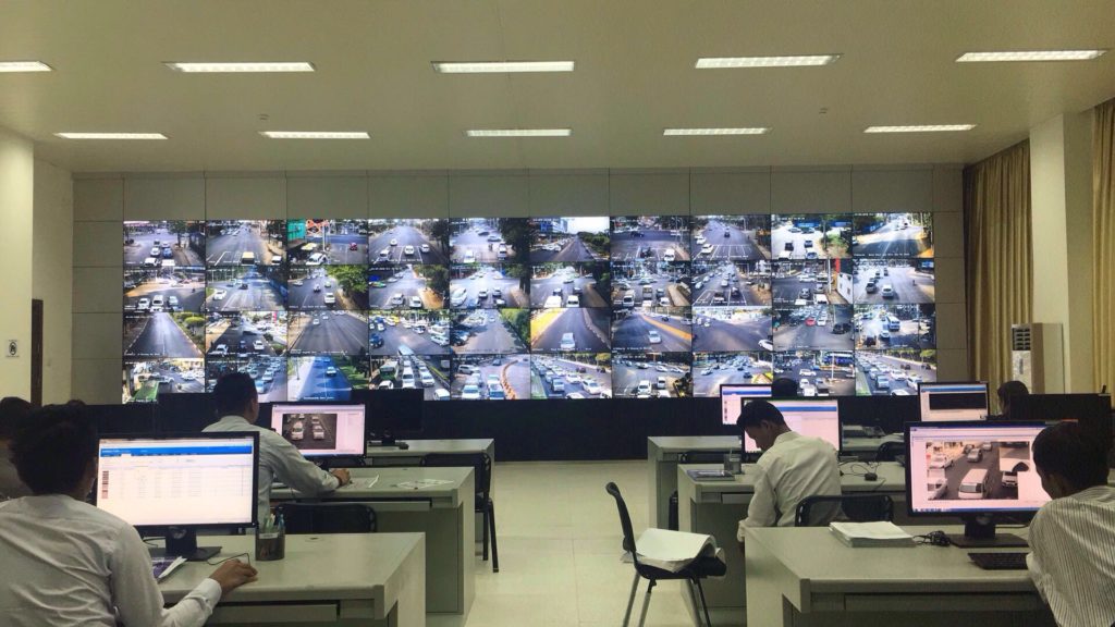 Operators watching a wall of live road cameras in the Yangon traffic control center