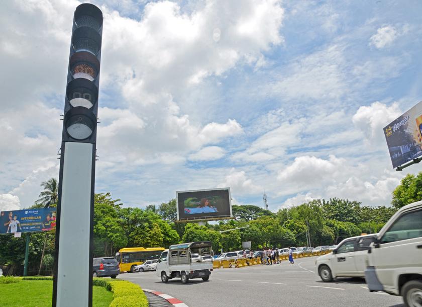 A traffic signal beside a busy Yangon junction